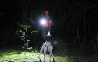 Professional schweiss dog handler using Suprabeam headlamp and flashlight